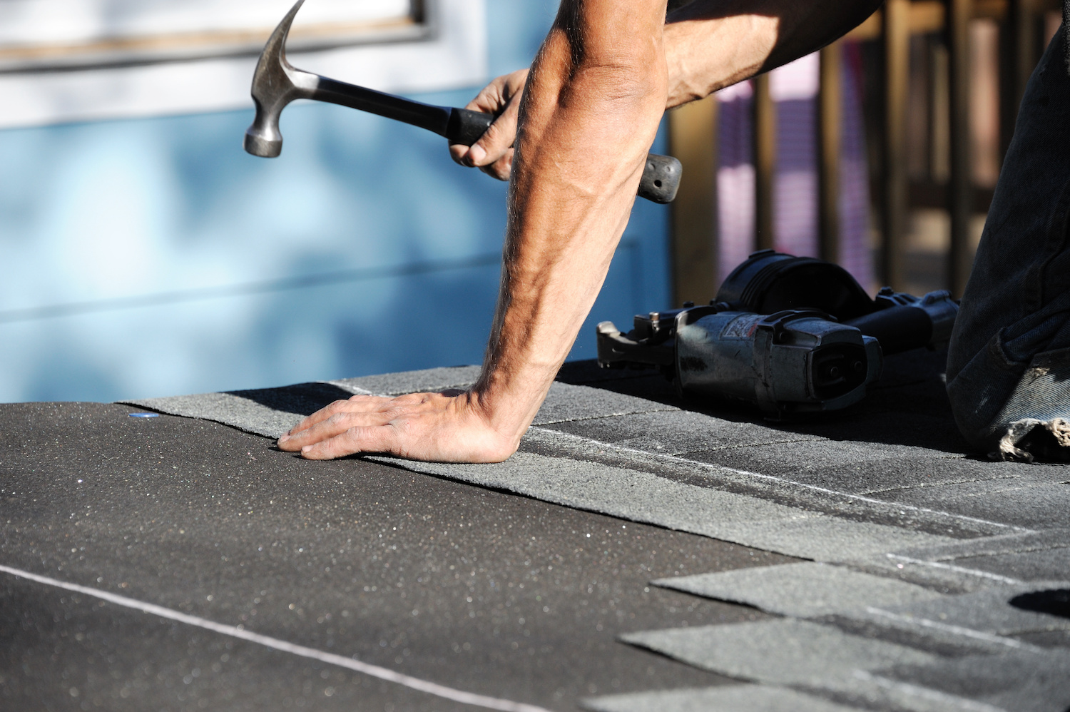 diy roof repair hammering shingles