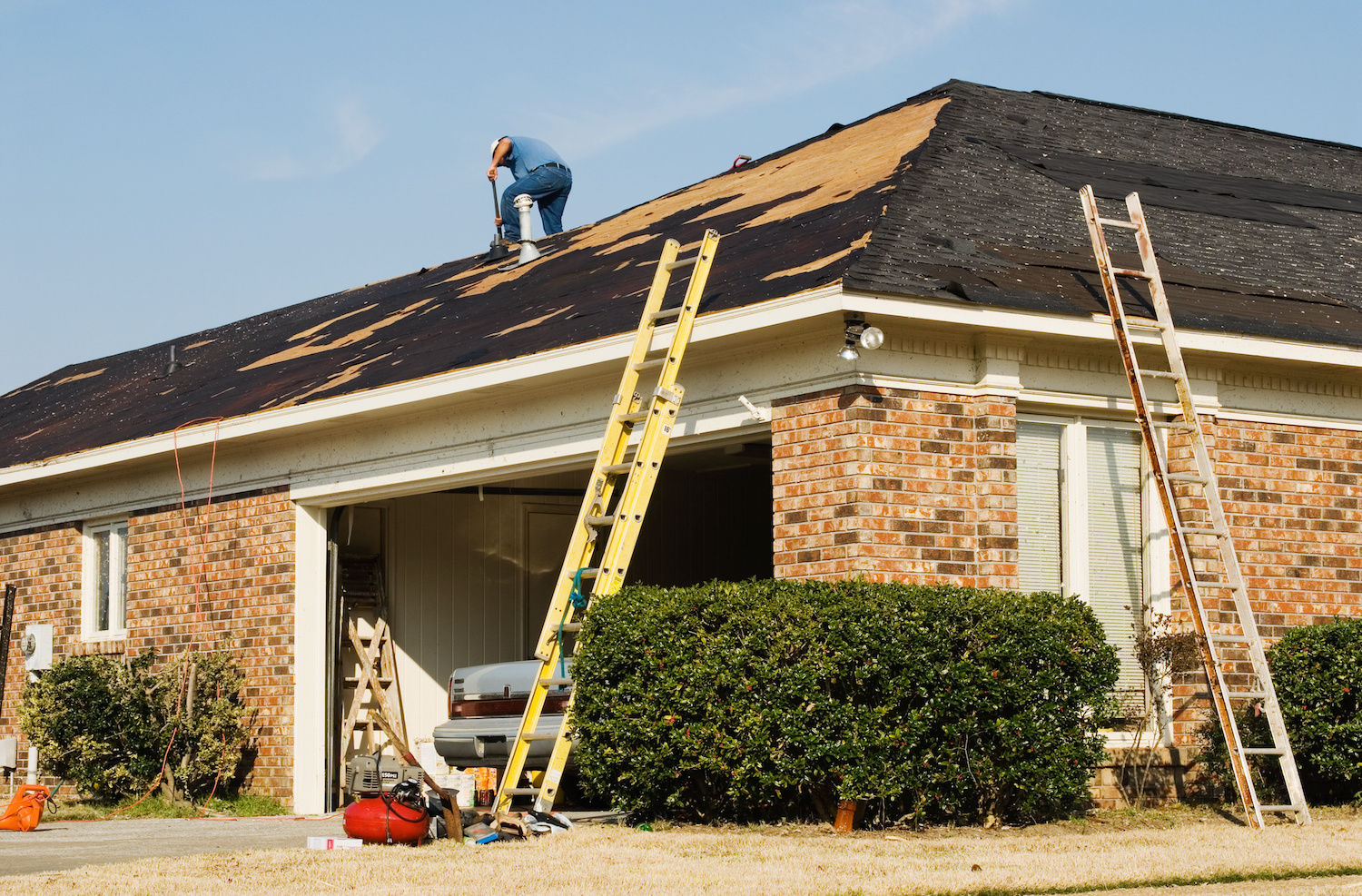 diy roof repair man scraping roof