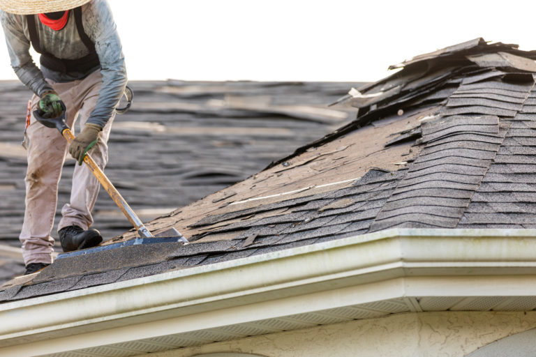 how to remove shingles from roof man shovelling
