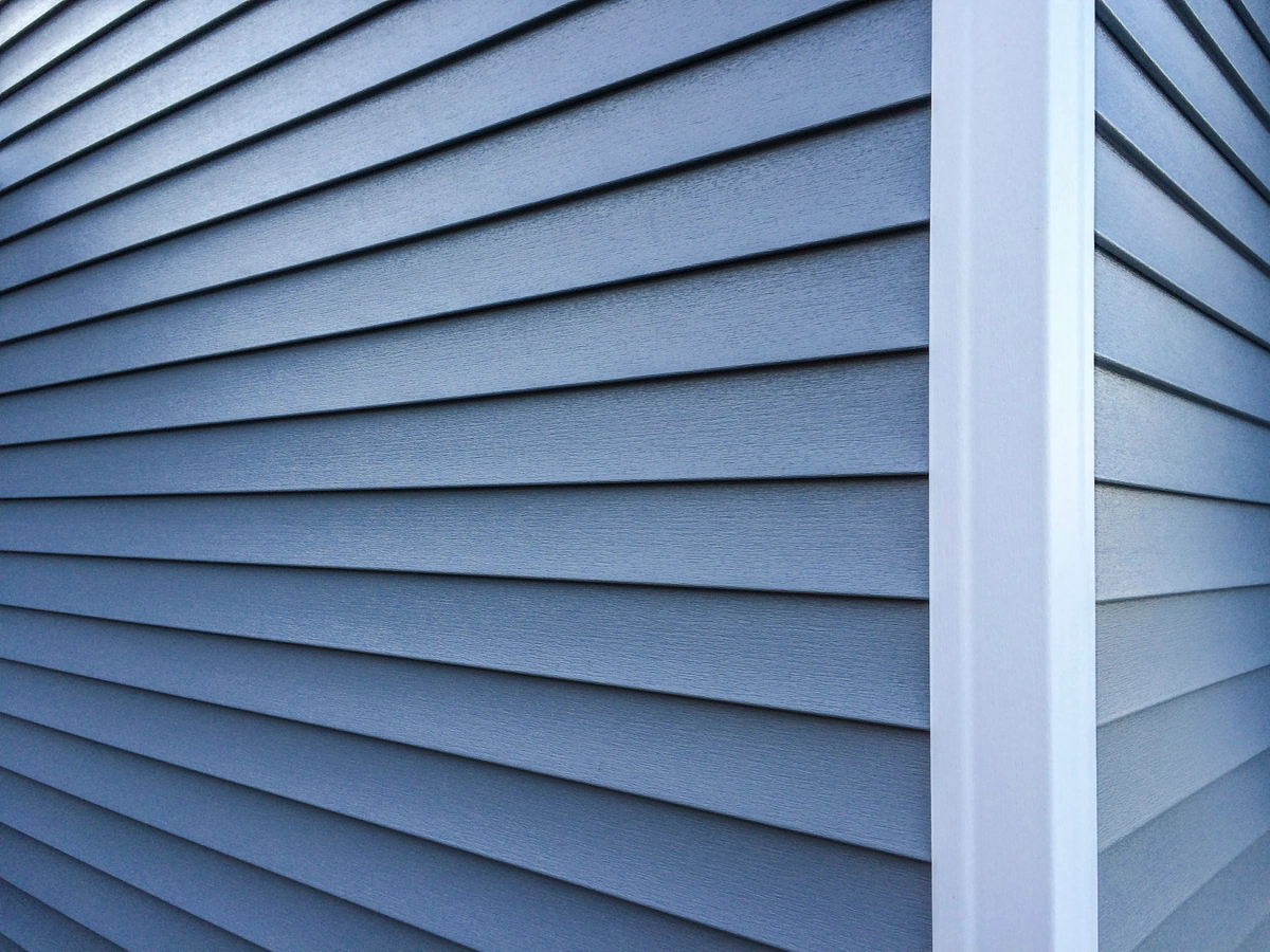 on residential house blue vinyl siding with white trim
